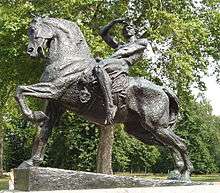 outdoor statue of a horse with a naked male rider