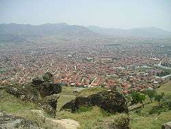 the red-roofed buildings of Prilep and surrounding mountains and vallies