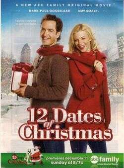 Miles (Mark-Paul Gosselaar) and Kate (Amy Smart) standing outside in winter; Miles is holding a wrapped present