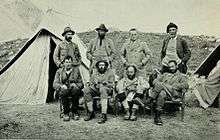 Eight men by two tents. George Bernard Shaw said they "looked like a Connemara picnic trapped in a snowstorm"