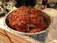 uncooked bacon wrapped turkey