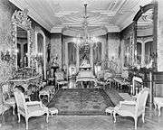 Drawing room with chandelier, gilded furniture, and ornate mirrors