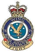 Military crest for 78 Wing, Royal Australian Air Force, with eagle carrying sword in front of Southern Cross constellation; the motto reads "Fight"