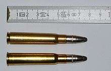 Two bullets side by side for comparison with a tape measure for scale.