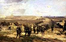 Colour painting depicting a battle scene in which a line of soldiers advance on foot towards a ridge. To their right mounted soldiers move to the rear, while a tank is on the right
