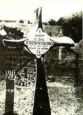 Crucifix, made from an aeroplane propeller, in a cemetery. The inscription reads "Lt. Col. R.S. Dallas DSO DSC ... Killed in Action"