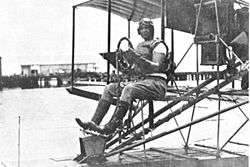 photo of Cunningham sitting in a biplane trainer