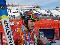 A man wearing skiing gear, being interviewed.
