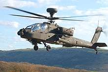 Helicopter in flight above heathland