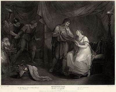 A print. The inside of a large grand tent. In the centre and right foreground are a young man and woman. Beyond them to the left, in another section of the tent, an older man is restraining an angry young man. In the far left background an ugly man looks on. The characters are dressed in a mixture of ancient, medieval and Georgian clothing.