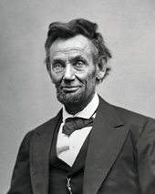 An older, tired-looking Abraham Lincoln with a beard.