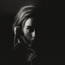 A dark black-and-white image of Adele holding a telephone to her ear