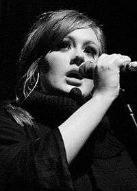 A black and white close up picture of a woman singing