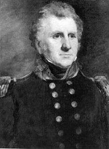 Black and white portrait of a bushy-haired man with sideburns and white eyebrows. He wears a dark military uniform with two rows of buttons and epaulettes.