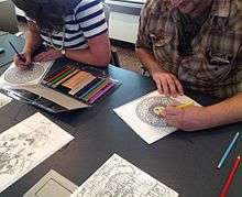 Adults coloring at the Southeast Steuben County Library