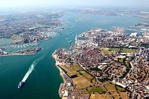 An aerial view of western side of Portsmouth (including Gunwharf Quays, the dockyard and the Spinnaker tower), the harbour itself, and the town of Gosport.