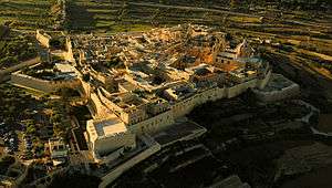 Aerial view of a fortified medieval city.