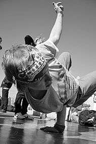 A black and white photograph of a Russian b-boy dancing in Moscow.