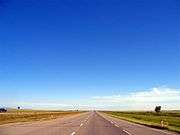 Alberta Highway 2 is a lightly travelled, four lane divided highway through farmlands near Claresholm, Alberta.