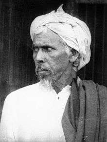 Older man in traditional dress, looking left