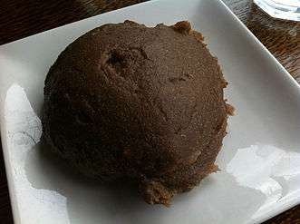 Picture of a brown doughy Yoruba dish known as Amala on a plate