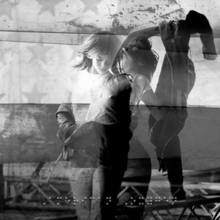 Two black and white images of Rihanna superimposed on each other, against a backdrop featuring the American national flag