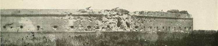 panoramic photo across swamp showing pot-marked fort (a) south wall (left) and (b) east wall (right), (c) two large holes in southeast corner