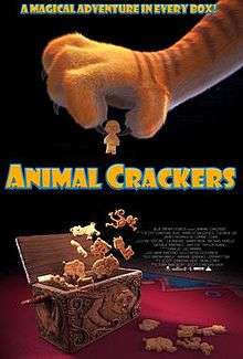 A tigers paw holding one animal cracker that has been taken out of a box full of animal cracker. The words "Animal Crackers" are in the middle and the words "A magical adventure in every box" are at the top both in orange with a blue border.