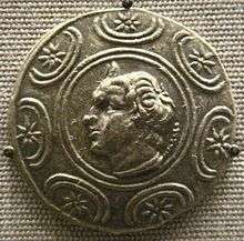 A coin depicting a man with wavy hair