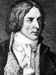Black and white print shows a clean-shaven man with hair reaching almost to his shoulders. He wears a civilian coat open at the front with a white shirt and white scarf around his neck.