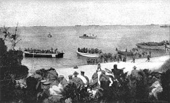 Boats carrying soldiers conduct a beach landing