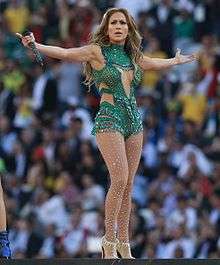 Jennifer Lopez onstage in a brief, green outfit