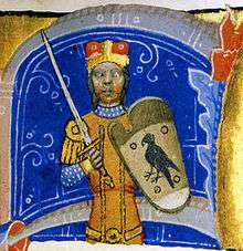 An armed men, wearing a crown, a sword, and a shield depicting a bird of prey