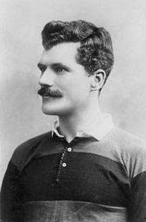 Profile photograph of Arthur Gould wearing the black and amber hooped shirt of Newport RFC.
