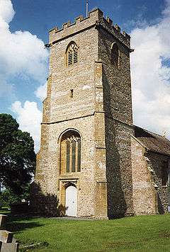 Stone two stage square tower with buttresses.