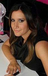 Head and shoulders of Tisdale in her twenties. Her dark brown, straight hair is parted to her left, and falls over her right ear.