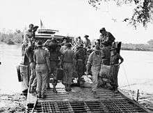 Soldiers disembark from a landing craft