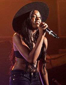 Colour photograph of Azealia Banks performing live in 2012.