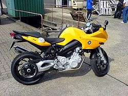 Yellow BMW F800S parked on concrete