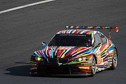 The Jeff Koons-designed BMW Art Car on a race track