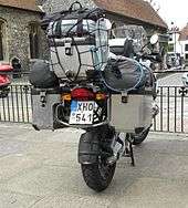  Rear view of motorcycle fitted with panniers, top box, and extra soft luggage