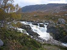 Wide falls in rocky hilly grassland