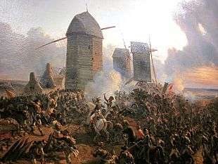 Painting shows ranks of soldiers moving up a hill topped by three windmills.