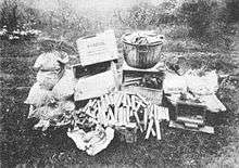 boxes of Pyrotol, sticks of dynamite, sacks of explosives and wiring in a pile