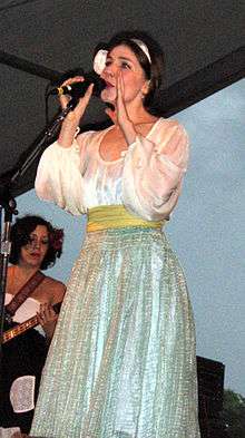 Becky Stark from Lavender Diamond singing onstage in a silver dress