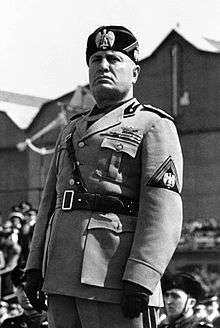 Benito Mussolini dressed in the fascist uniform addressing troops