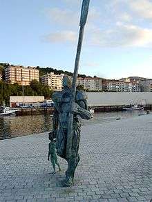 Statue of a man carrying a large oar