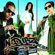 A split portrait of a black man on the left split, a brunette woman on the center split and a white man on the right split. The two men are posing while wearing bling jewellery and dark sunglasses. The woman is posing in a white dress with her one arm on her hip. Below them is the name 'N-Dubz' and the title 'Best Behaviour'.