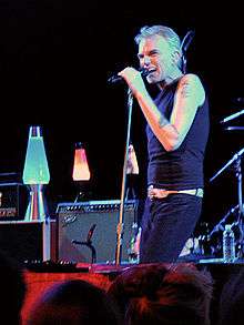 Billy Bob Thornton standing, singing into a microphone