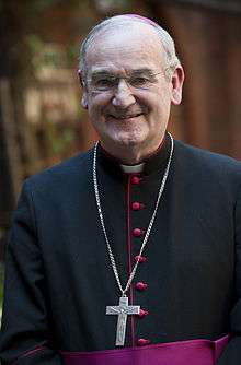 Portrait of Bishop George Stack in cassock with red piping, and pectoral cross